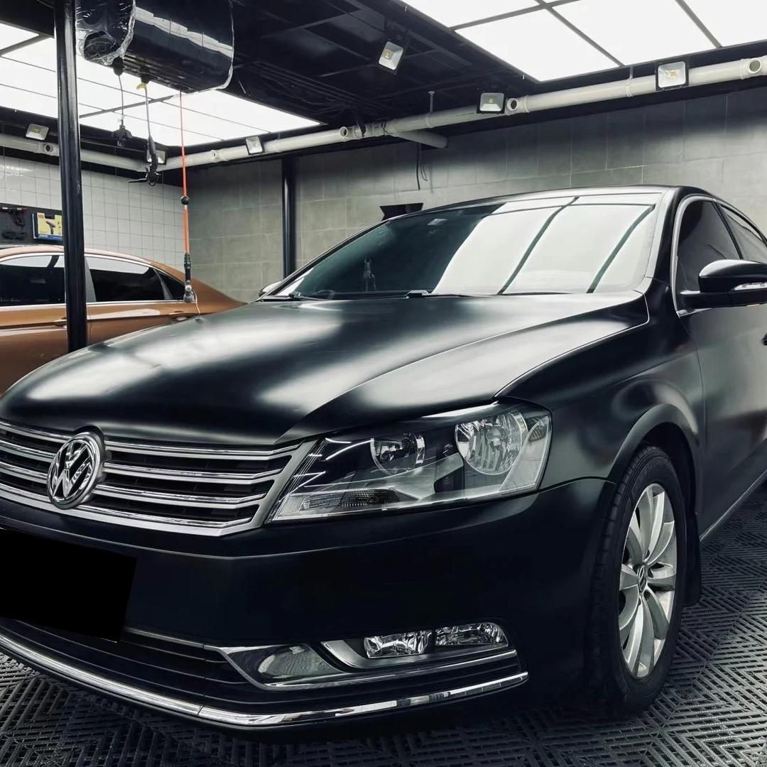 Sleek front hood contours covered in metallic deep black car wrap film, radiating a stealth tactical fighter aura with zero chemical odor, by ALUKOCARWRAP.