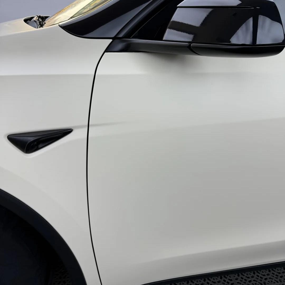 Macro view of Ultimate Flat Car Wrap detailing the premium zero grain PET texture and smooth seamless bumper wrap tuck.