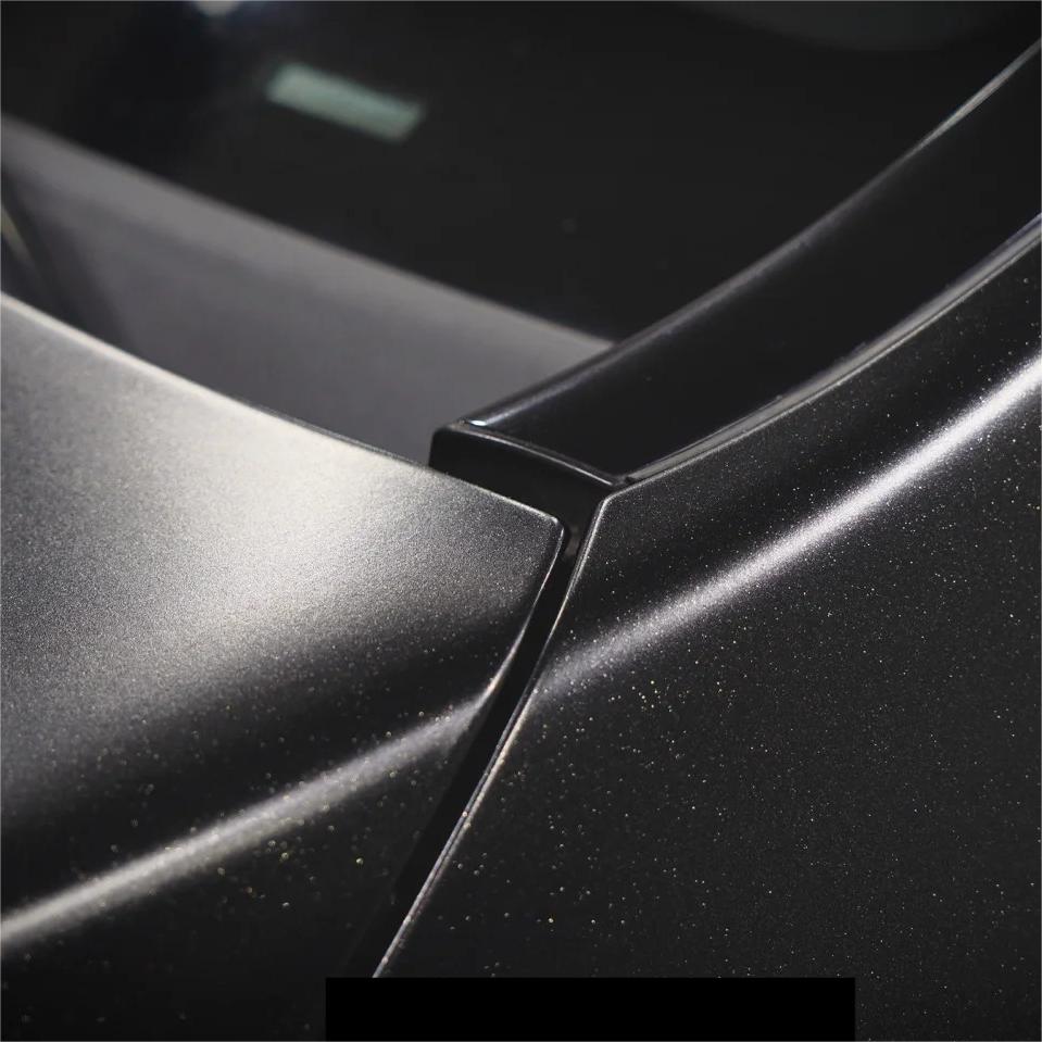 The striking juxtaposition between a matte black car wrap base and crystalline brilliance, using premium ALUKOCARWRAP metallic black car wrap vinyl.