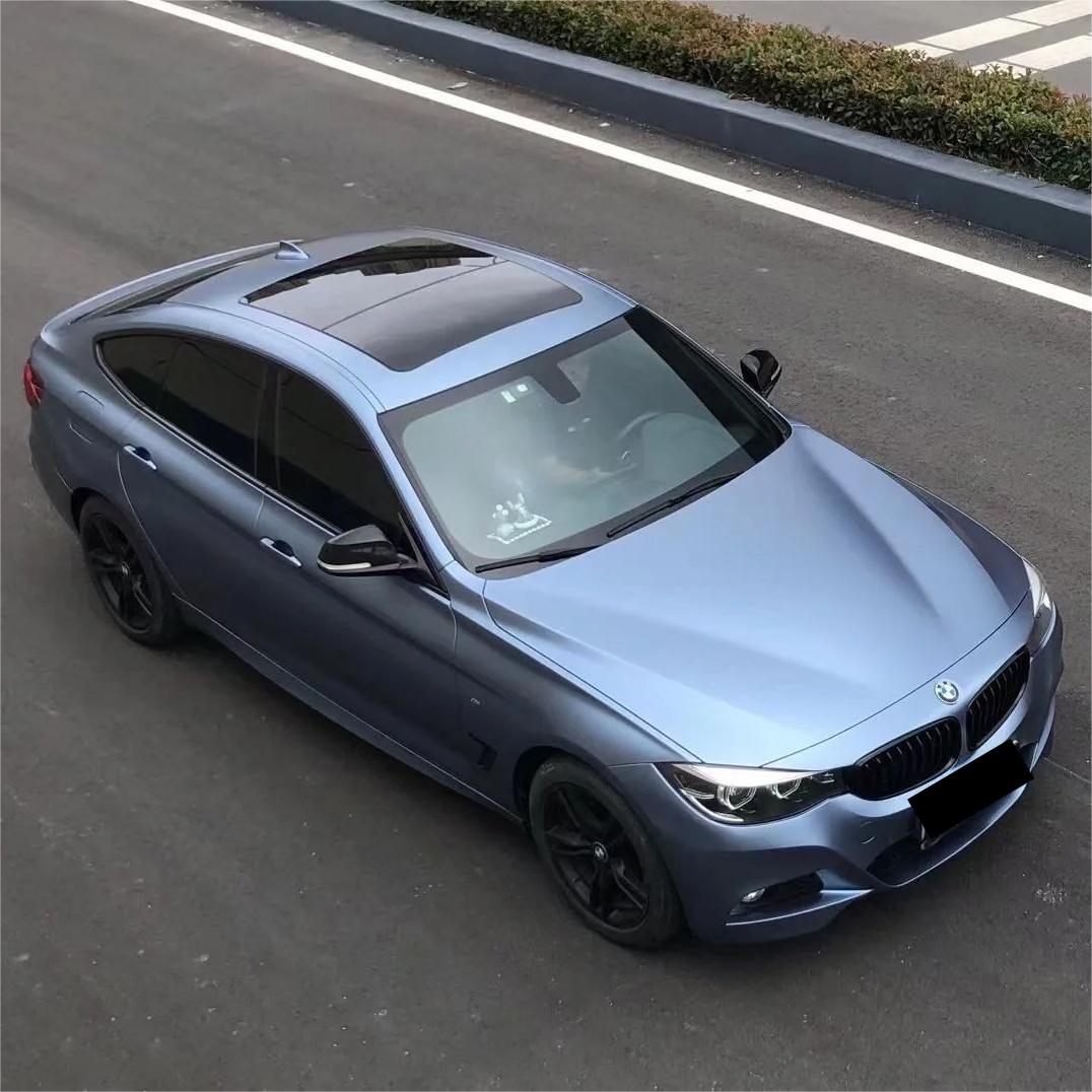 A menacing, lightning-evoking stance on an executive sedan wrapped in ALUKOCARWRAP matte blue car wrap, exhibiting a rich blue car wrap silhouette.