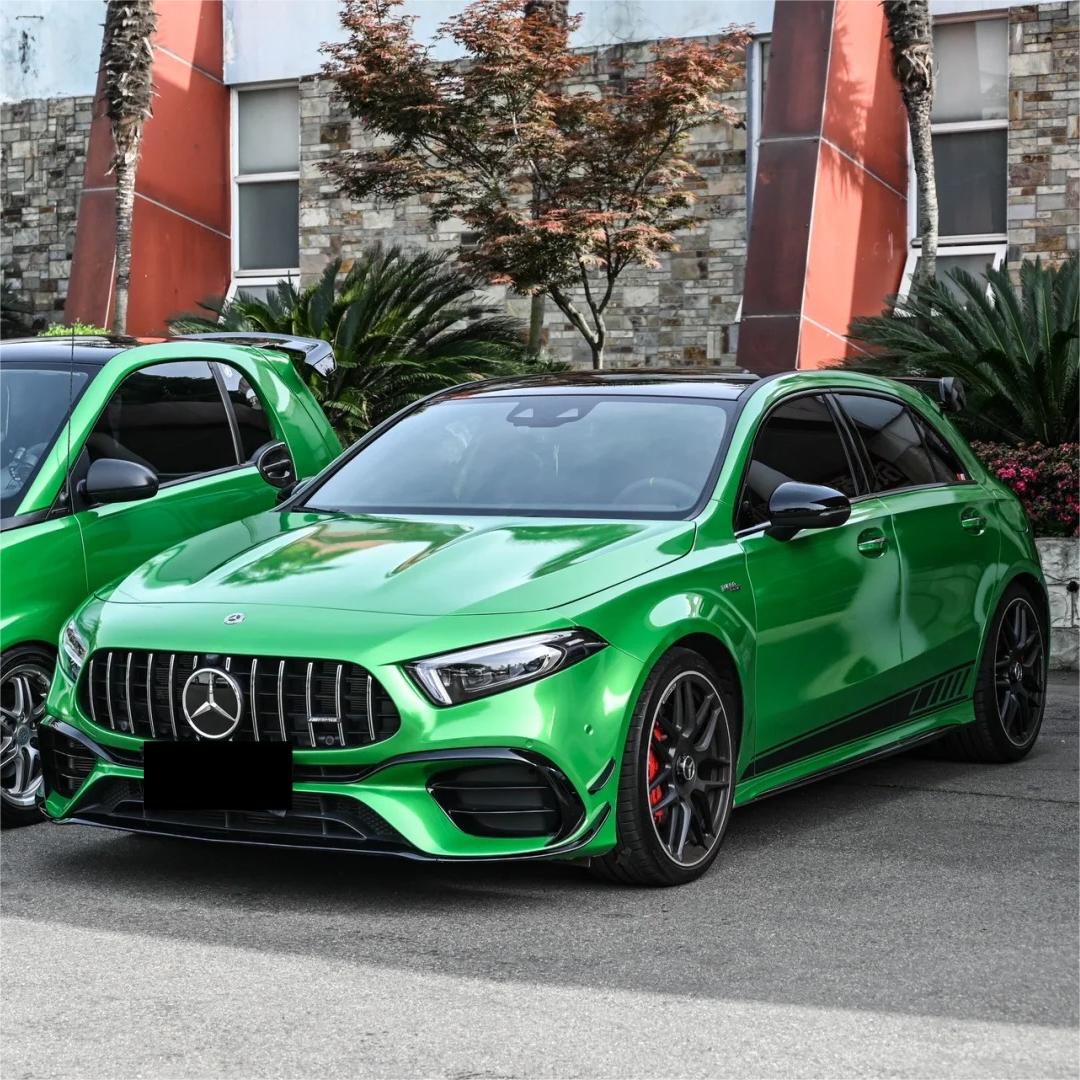 Luxury sport coupe covered in ALUKOCARWRAP Gloss Metallic Diamond Lizard Green Car Vinyl Wrap, radiating a deep botanical gloss metallic car wrap finish under afternoon sun.