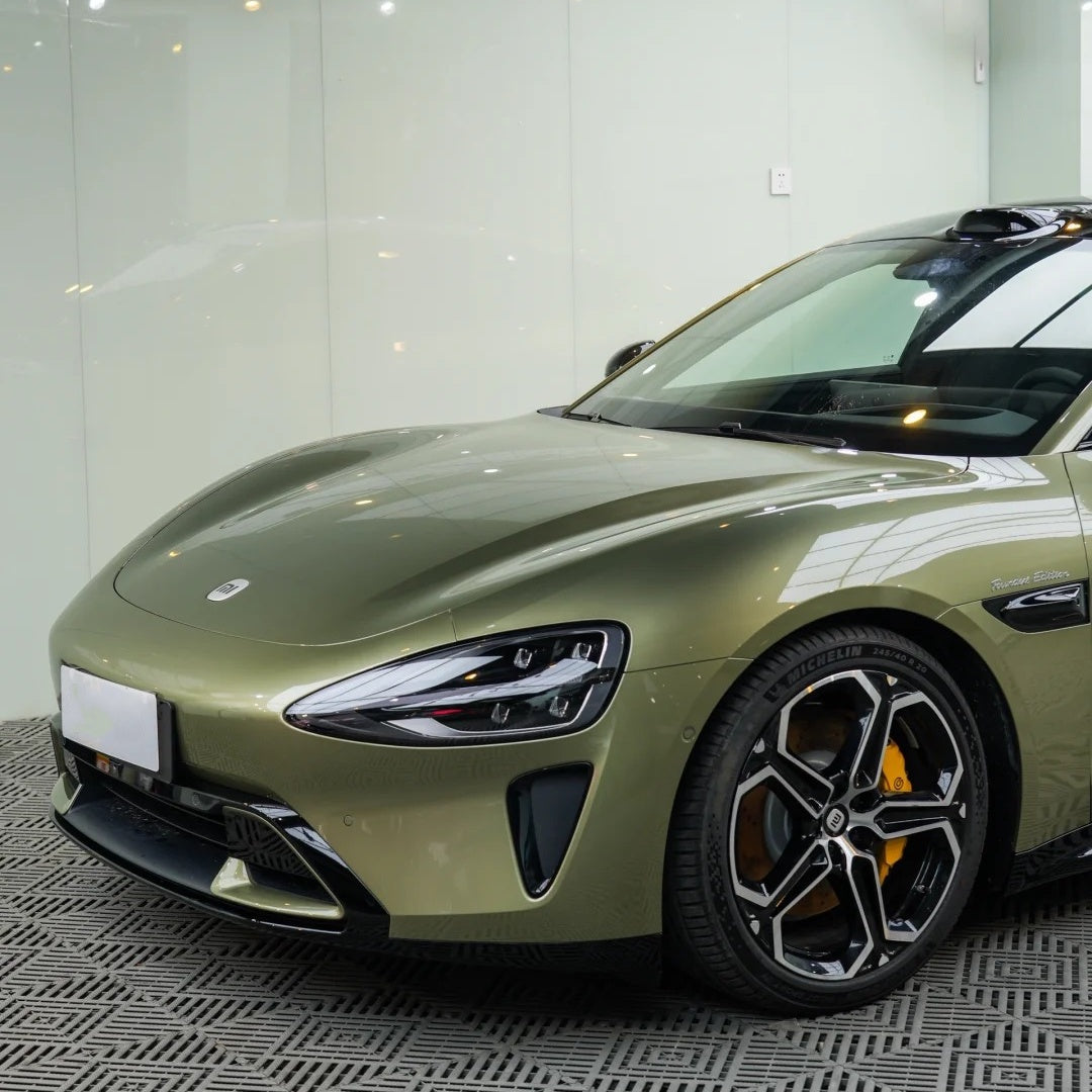 Close-up micro view of the gloss metallic olive green wrap edge tucked on a frameless door, proving zero orange peel PET liner smoothness.