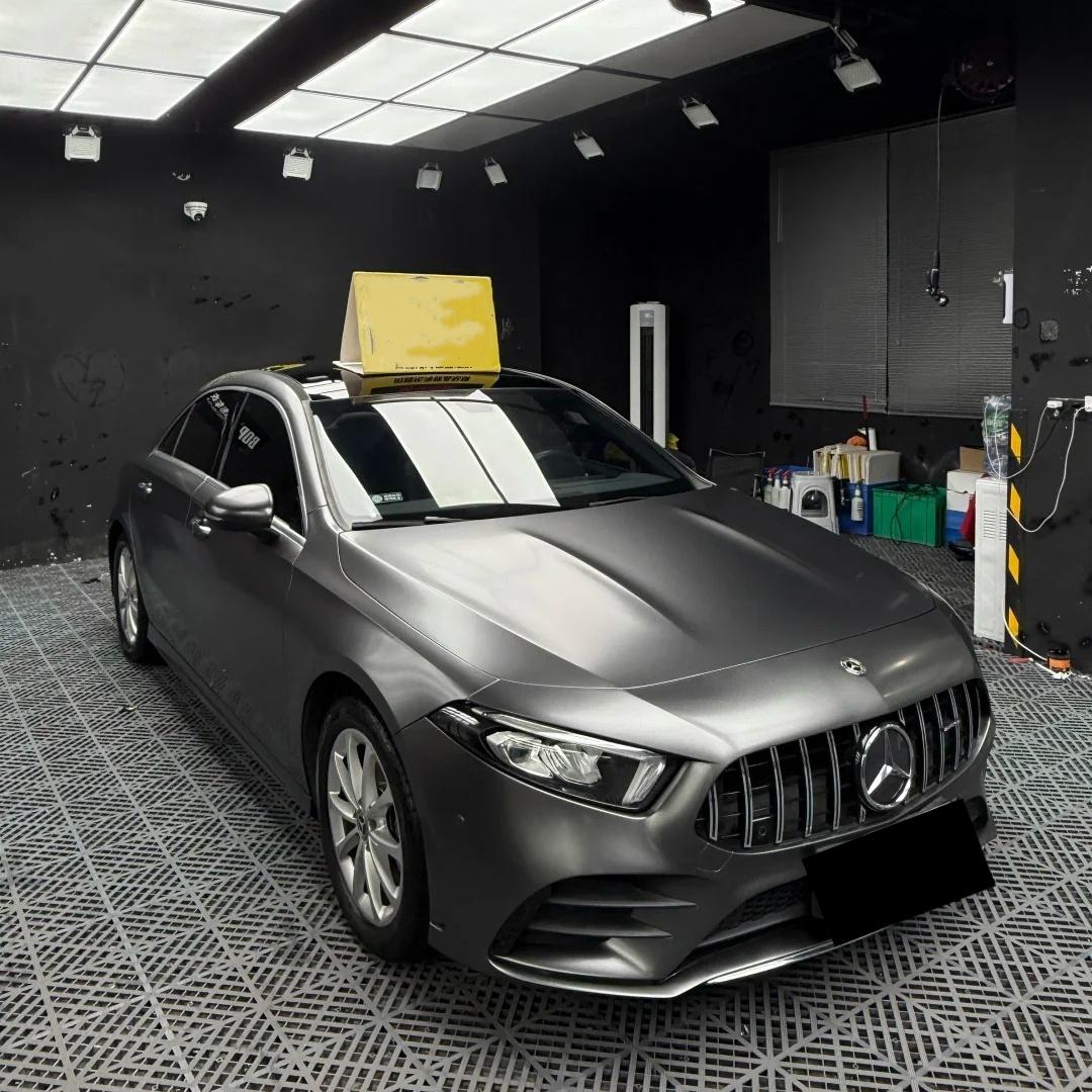 Performance sports car wrapped in ALUKOCARWRAP Valcanic Grey Car Wrap, delivering an aggressive matte metal aesthetic under outdoor natural sunlight.