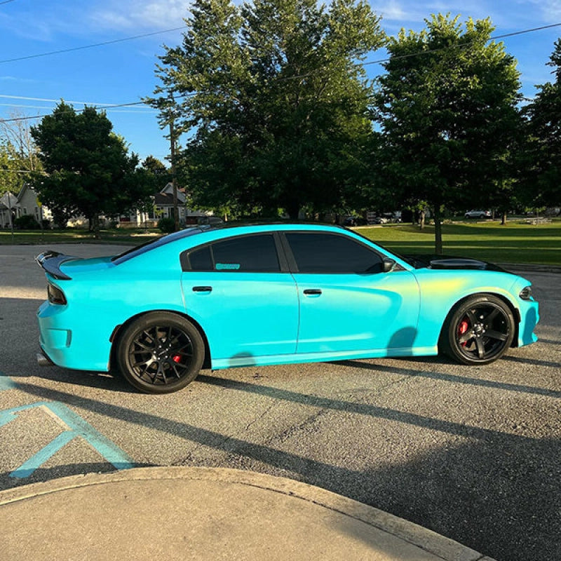Modified sports coupe wrapped in Aluko gloss metallic neon ice blue car vinyl wrap, glowing with a futuristic cyber electronic tint.