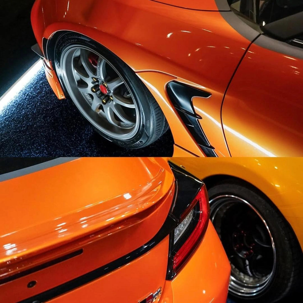 Close-up texture of gloss metallic fiery orange vinyl wrap with PET backing, showing smooth mirror finish on car surface.