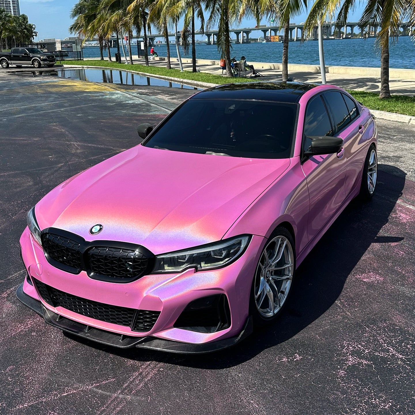 Prismatic rainbow reflections on the gloss metallic surface of Gloss Metallic Rainbow Laser Pink Car Vinyl Wrap PET.