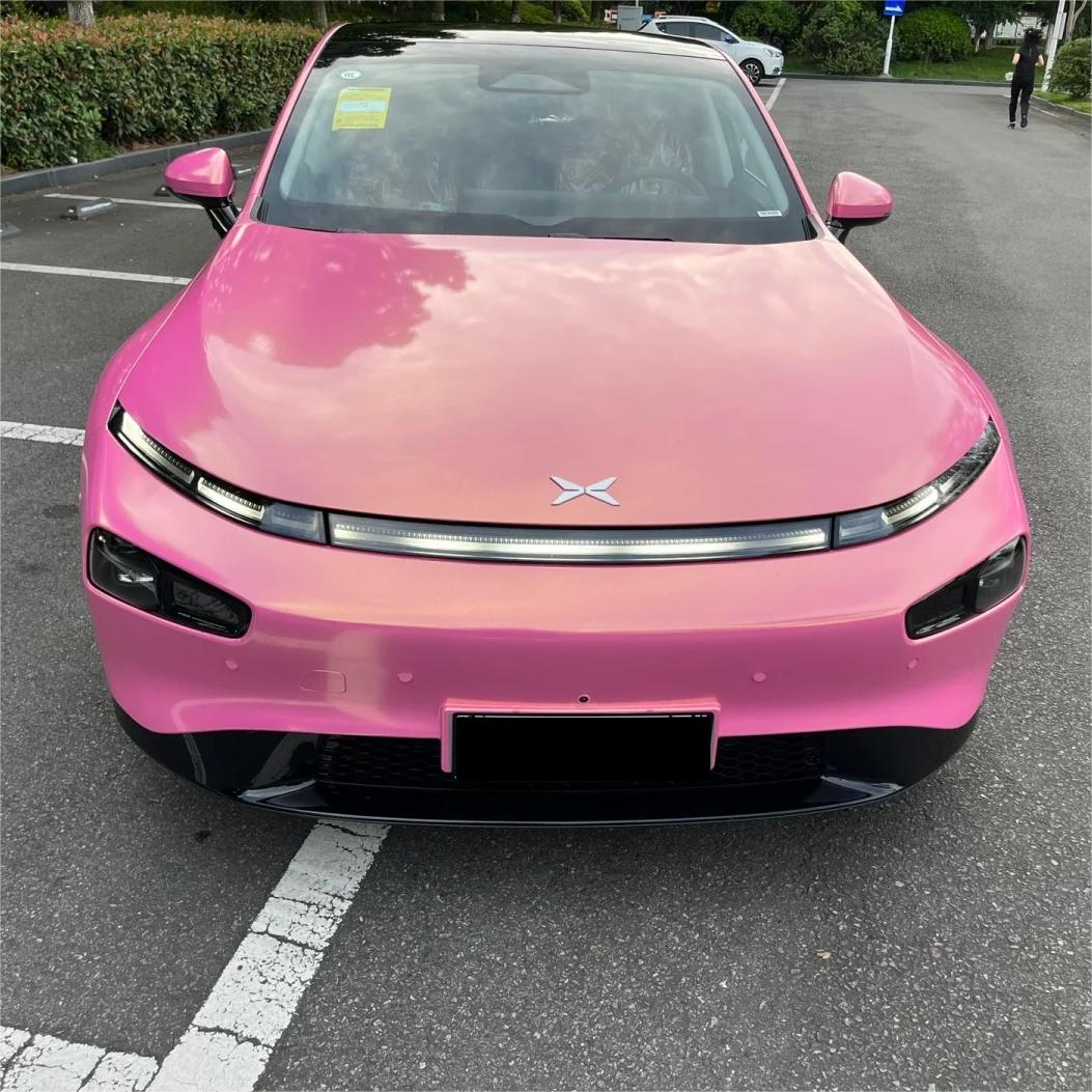 Ultra-smooth metallic pink car wrap finish on a luxury vehicle bumper, displaying ALUKOCARWRAP premium gloss coating.