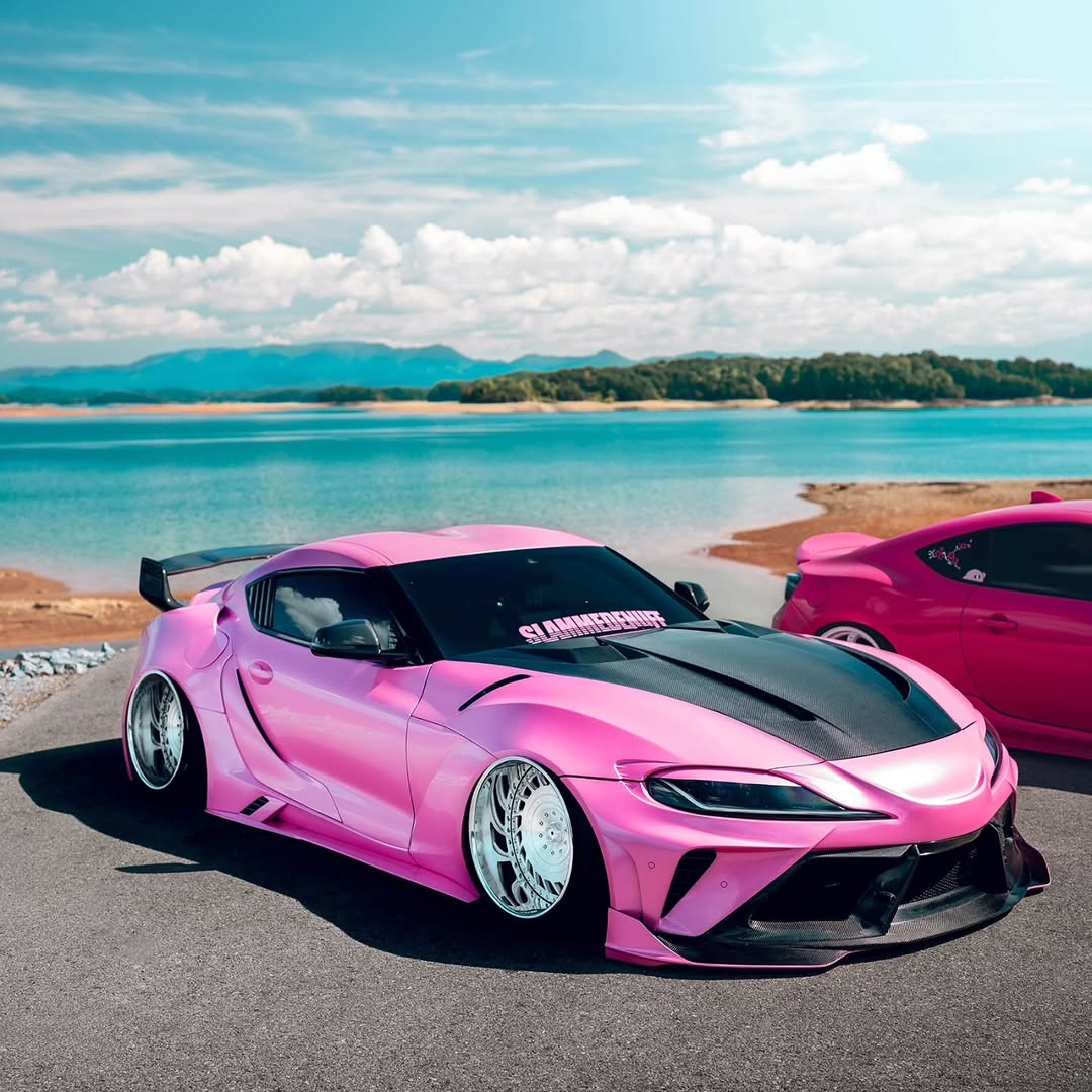 An elegant luxury electric car wrapped in Glossy Metallic Shell Pink Car Vinyl Wrap PET, capturing a soft liquid pearl gloss.