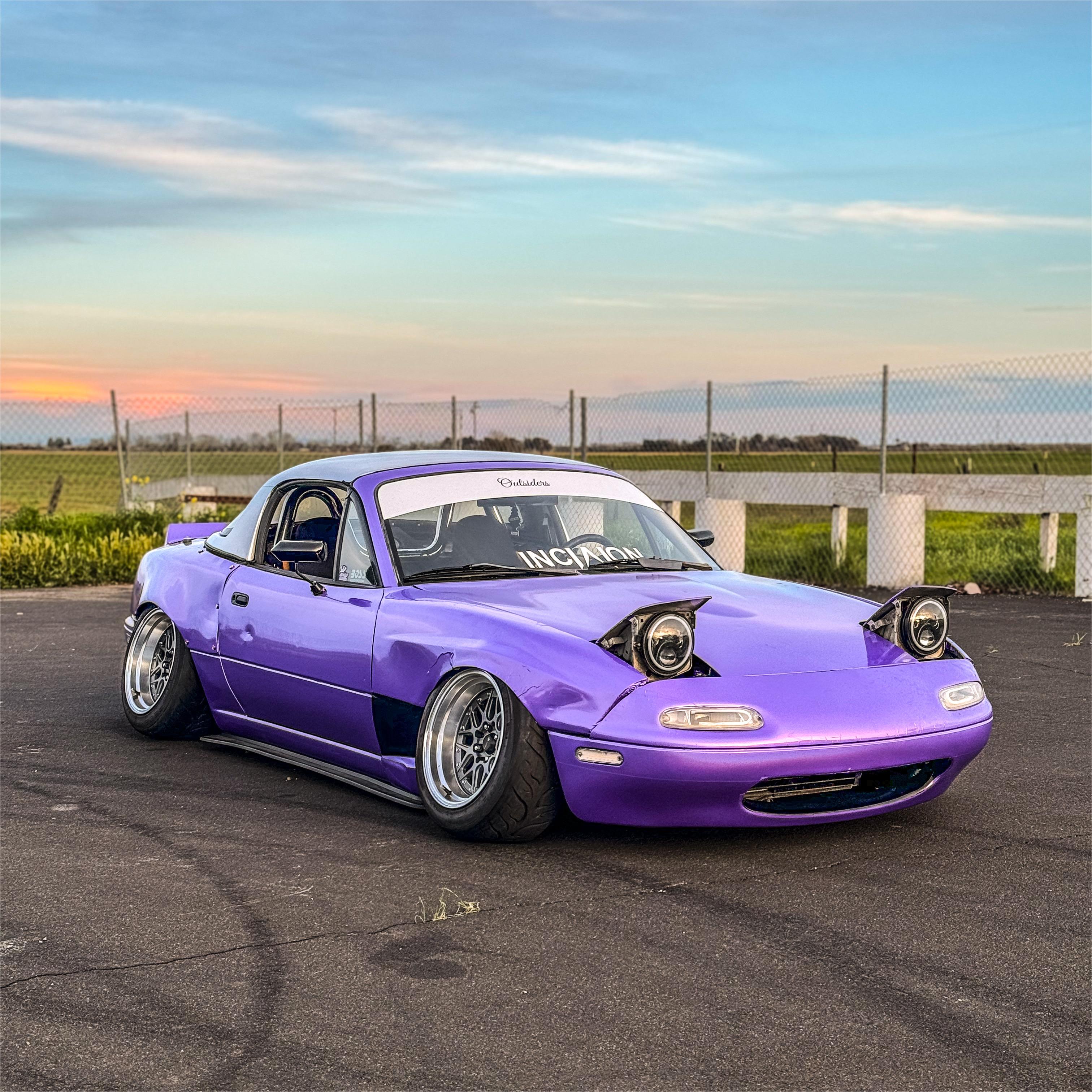 An electric coupe in Gloss Metallic Rainbow Laser Light Purple Car Vinyl Wrap, showing dynamic iridescent color shifting.