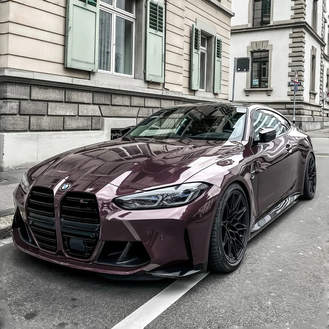 Custom sports car turning heads with a flawless Eve Purple Car Wrap in a professional showroom setting.