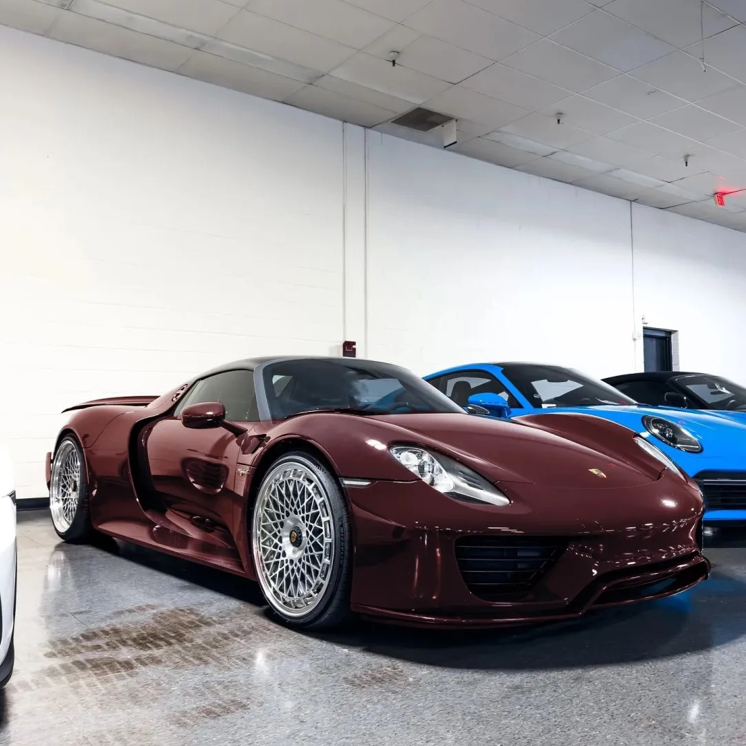 Exotic luxury coupe fully wrapped in ALUKOCARWRAP Metallic Red Car Wrap, delivering an intense blood-red metallic shine under brilliant sunlight.