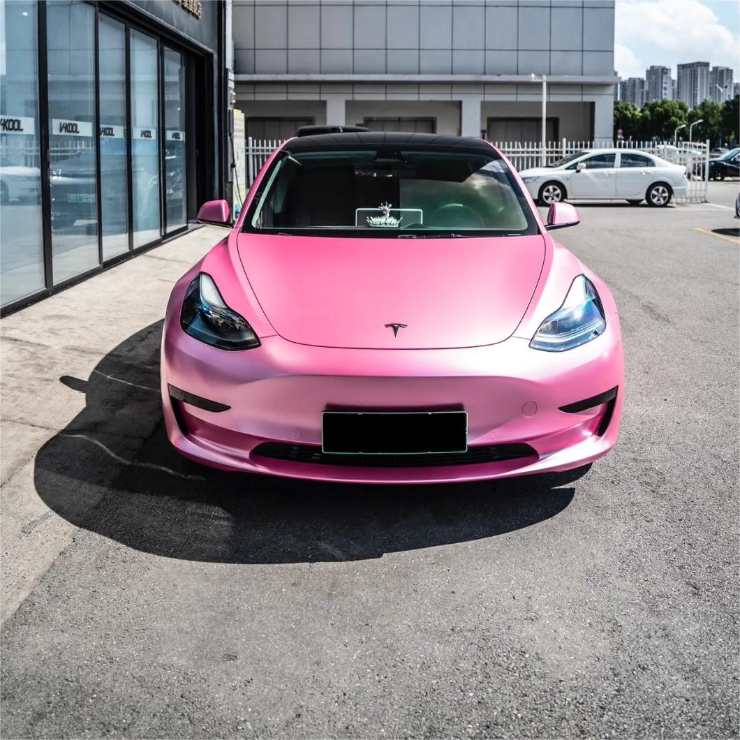 Close-up of car door contours showcasing the satin metallic texture and micro-flakes of ALUKOCARWRAP metallic shell pink car wrap under natural sunlight.
