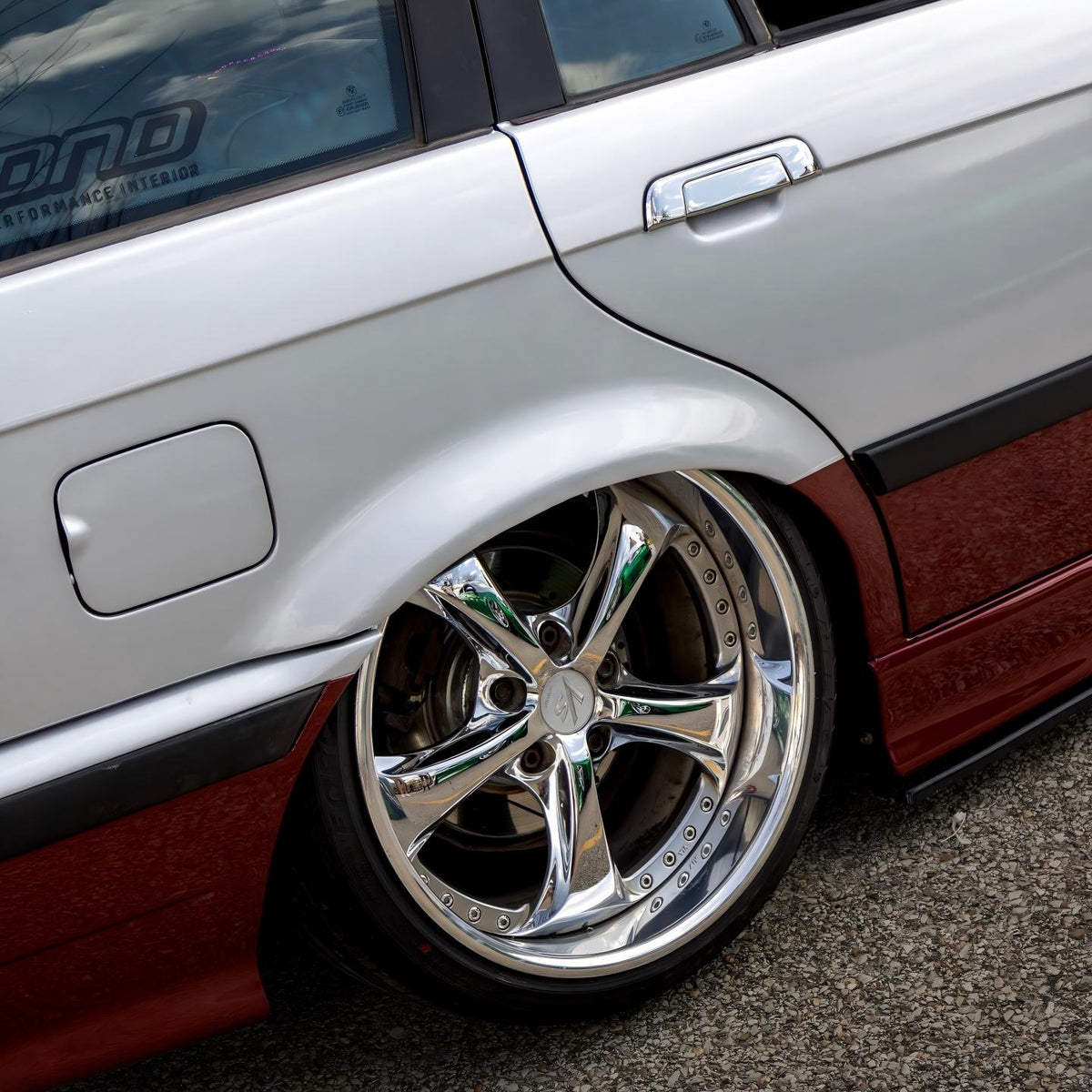 Dynamic rolling-shot aesthetic of a vehicle wrapped in ALUKOCARWRAP Gloss Metallic Diamond Silver Car Vinyl Wrap under glowing streetlights at night.