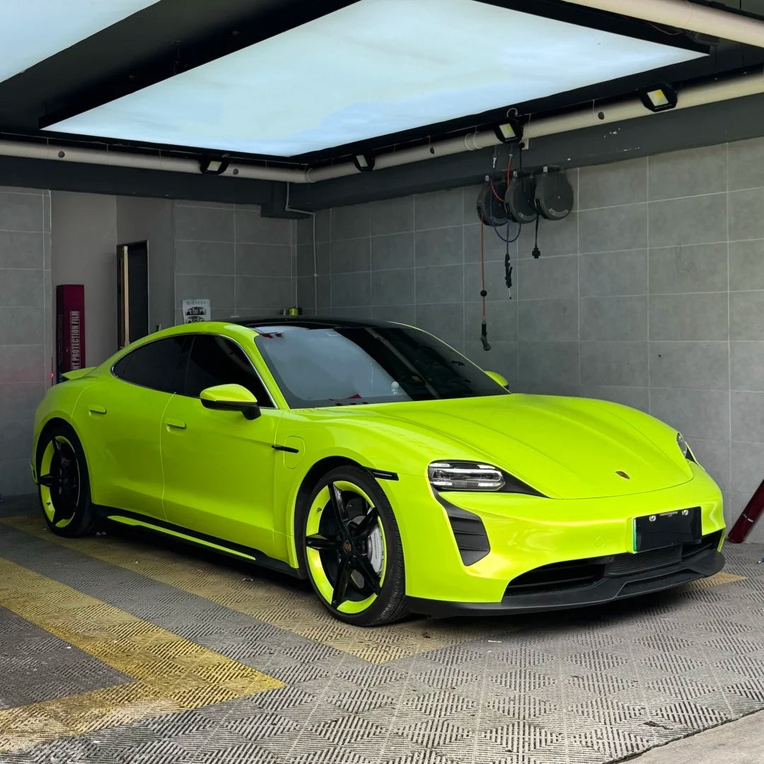 Exotic sports car fully wrapped in ALUKOCARWRAP Neon Yellow Car Wrap, glowing with high-visibility radiance under direct outdoor sunlight.
