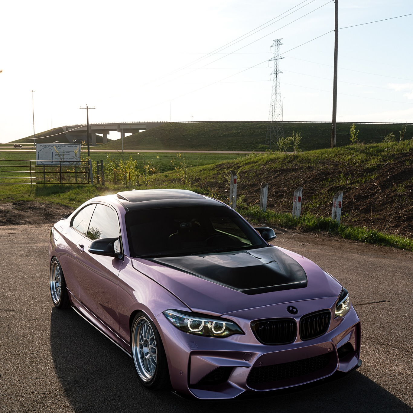 Sportscar fully wrapped in ALUKOCARWRAP Gloss Metallic Passion Pink PET vinyl, showing flawless body lines and deep metallic reflections.