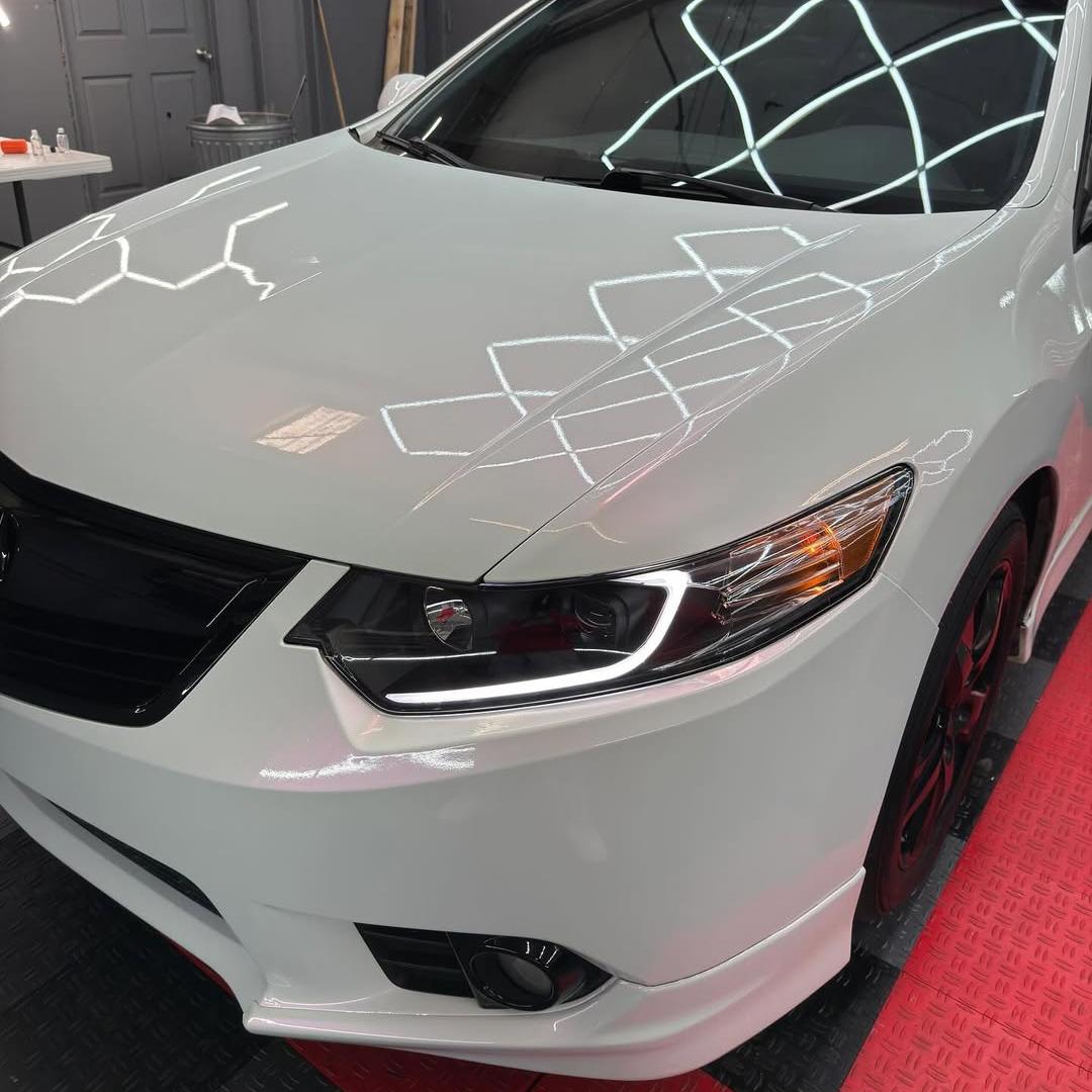 Metallic chameleon car wrap shifting from pearl white to gloss pink on vehicle