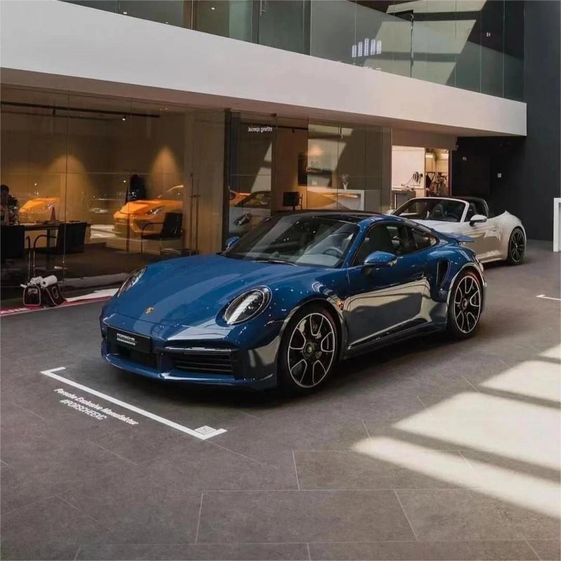 Luxury sports car wrapped in gloss petrol blue car vinyl wrap PET, displaying flawless mirror paint-like finish.
