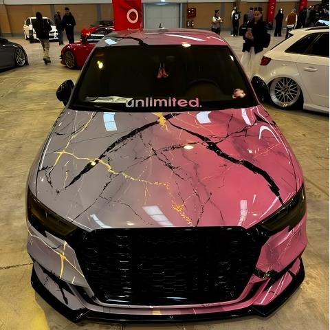 Close-up of gradient car wrap by ALUKOCARWRAP, capturing deep mineral crystalline fades on an artistic vehicle body line.