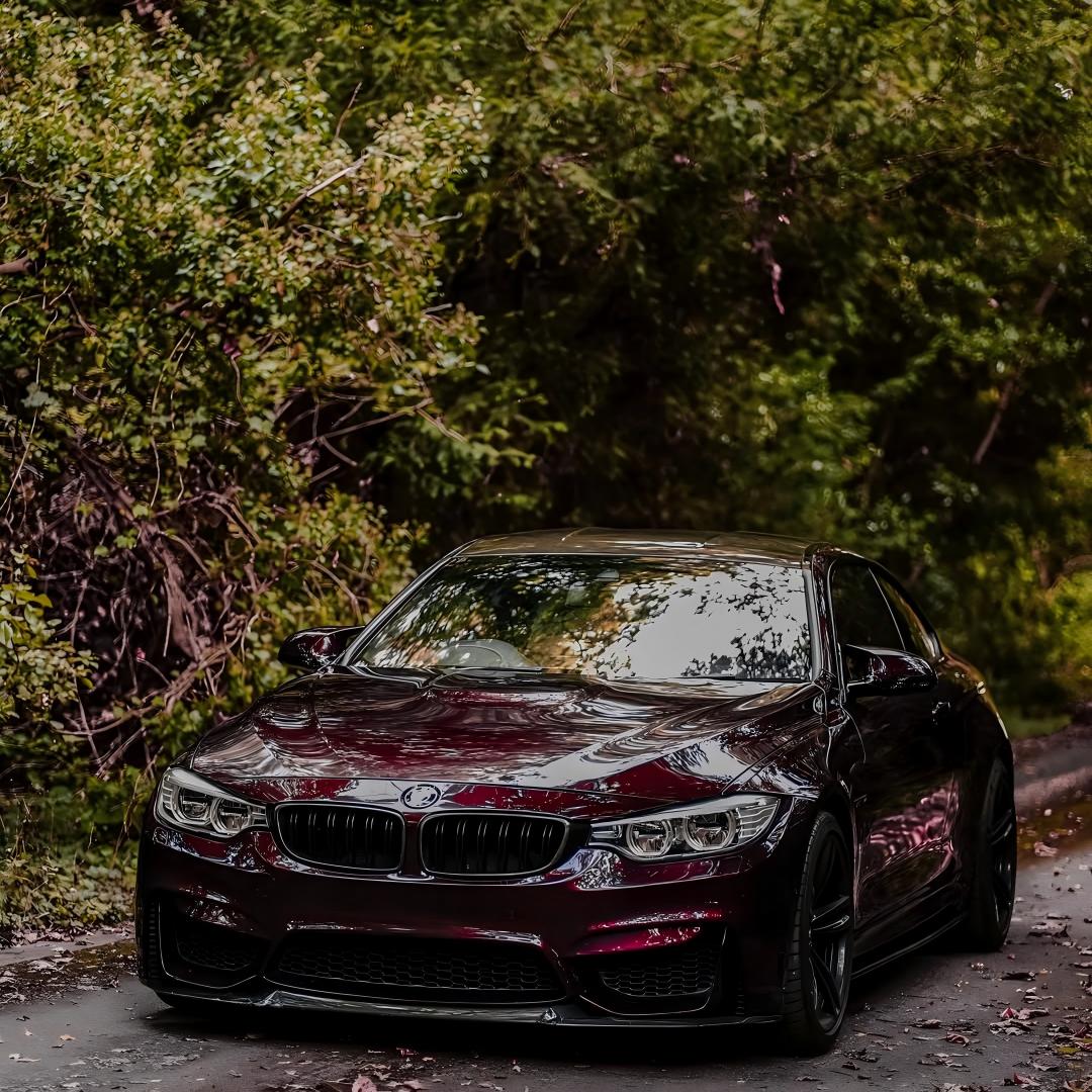 A luxury executive sedan wrapped in Gloss Metallic Plum Purple Car Vinyl Wrap PET, capturing regal deep berry violet gloss.