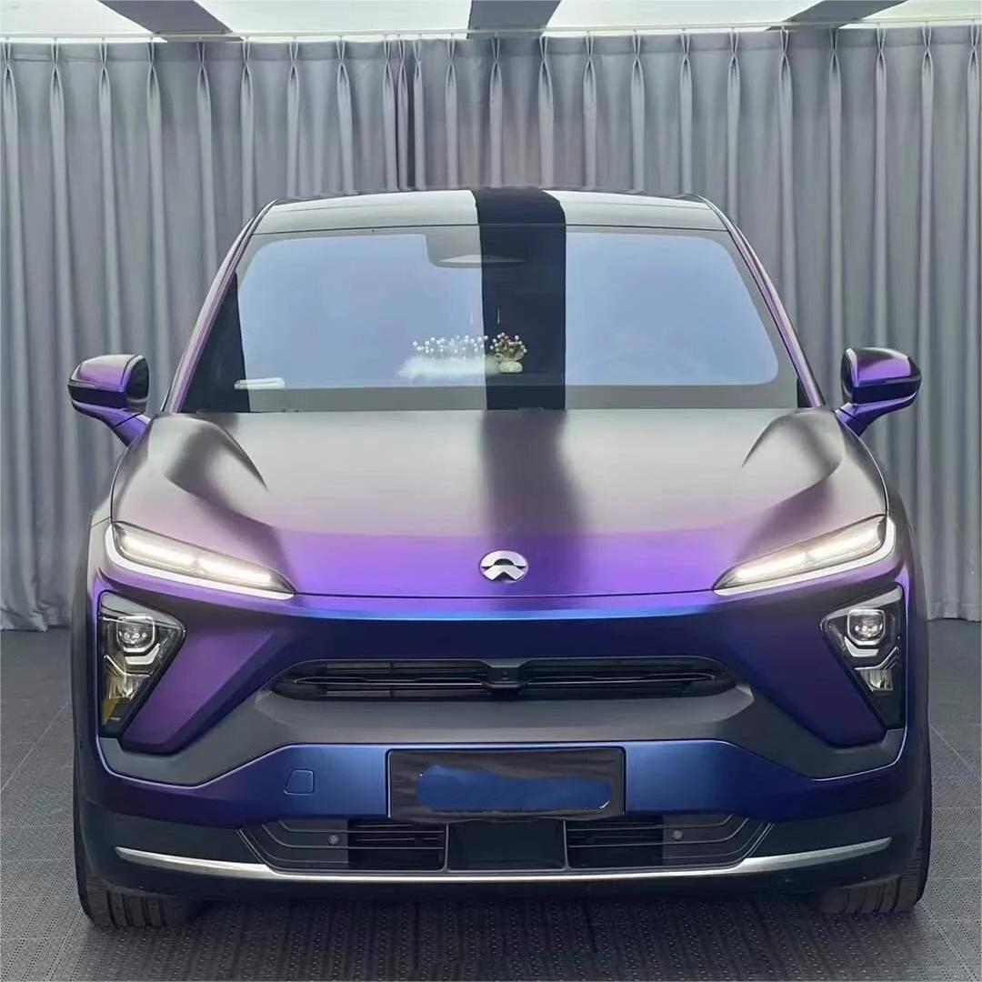 Dramatic color transformation from deep shadow purple to a molten lava red on an ALUKOCARWRAP Diamond Purple Car Wrap section.