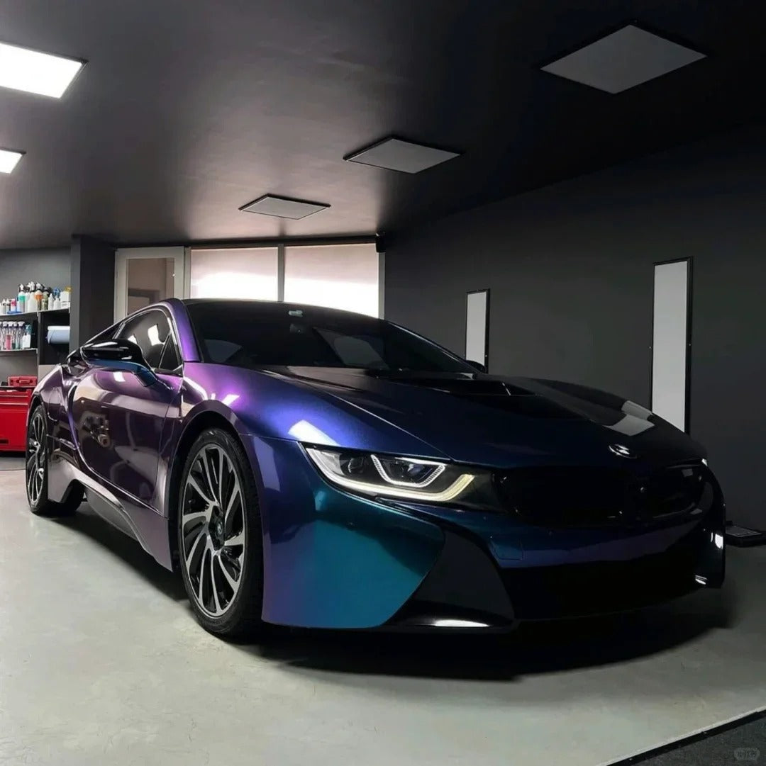 Luxury sports car customized with a vibrant gloss purple car wrap and shimmering metallic red car wrap finish.