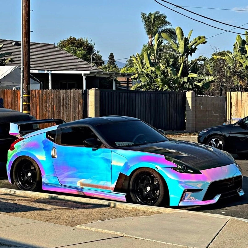 Rainbow holographic chrome white car vinyl wrap PET on vehicle under sunlight, showing gloss laser multicolor laser effect.
