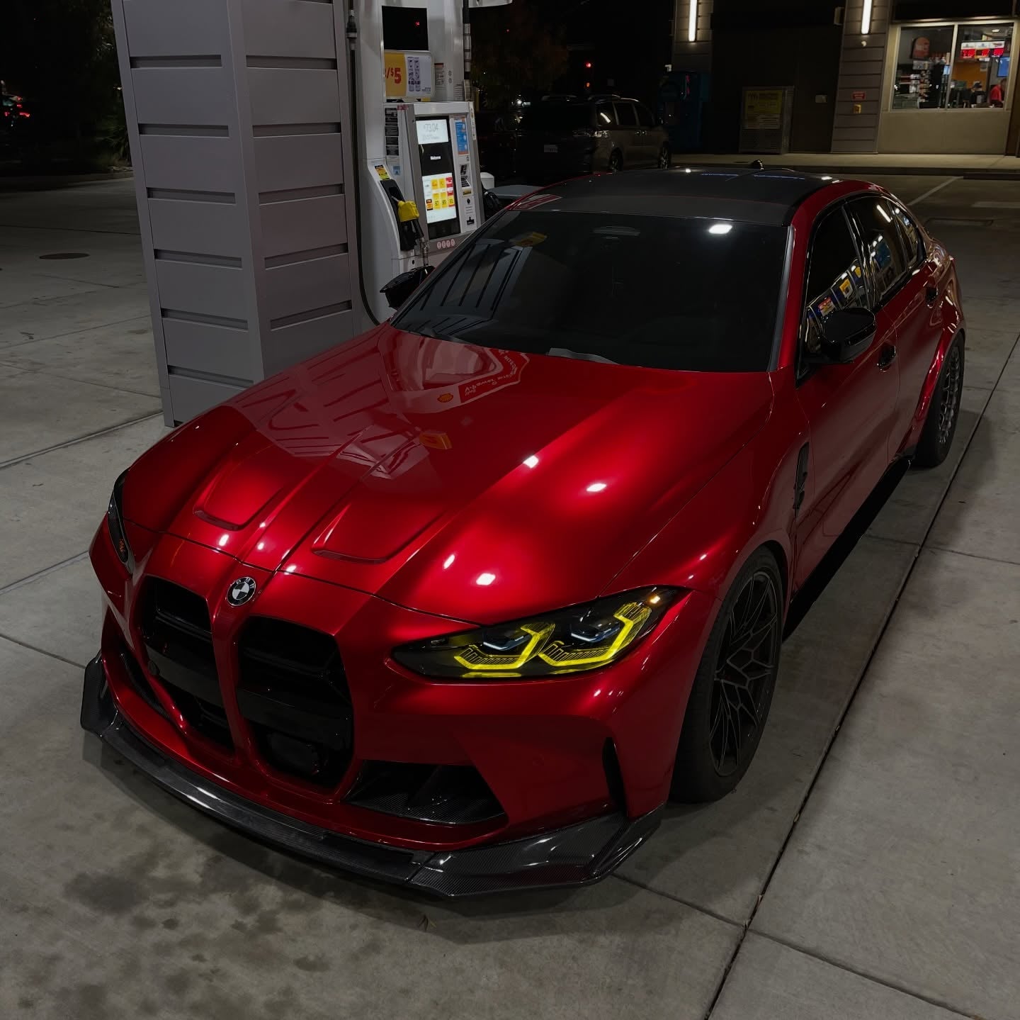 A low-slung supercar wrapped in Gloss Metallic Liquid Ruby Red Car Vinyl Wrap PET, capturing dynamic candy chrome gloss.