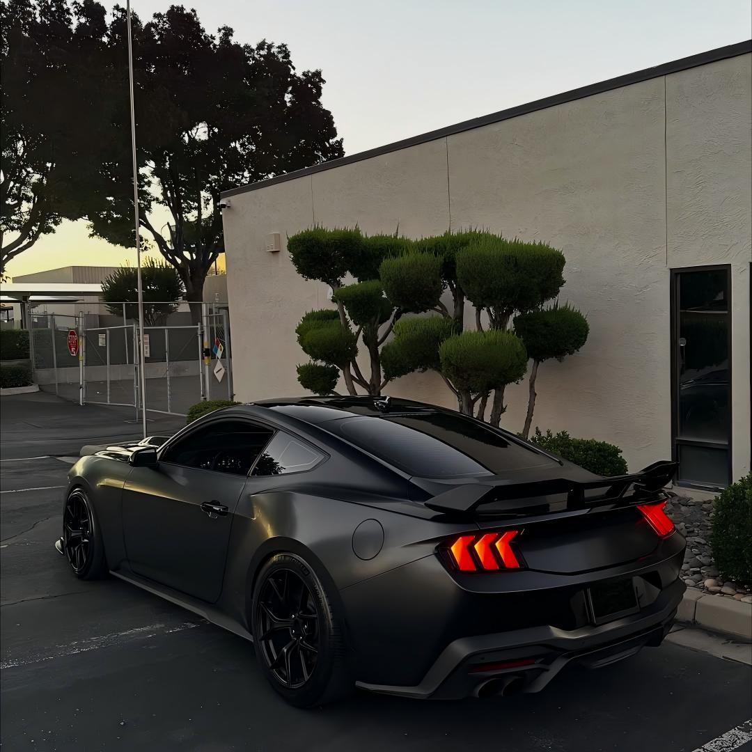 A stealth BMW M-Power coupe wrapped in Matte Satin Black Ceramic Black Car Vinyl Wrap PET, showing a liquid metallic sheen.