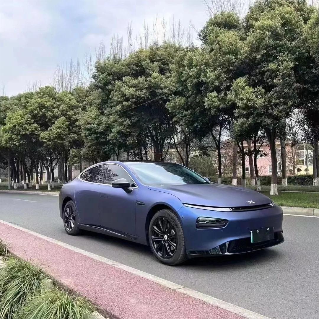 A luxury sedan fully wrapped in Matte Metallic Satin Dark Blue Car Vinyl Wrap, displaying elegant midnight silk metallic curves.