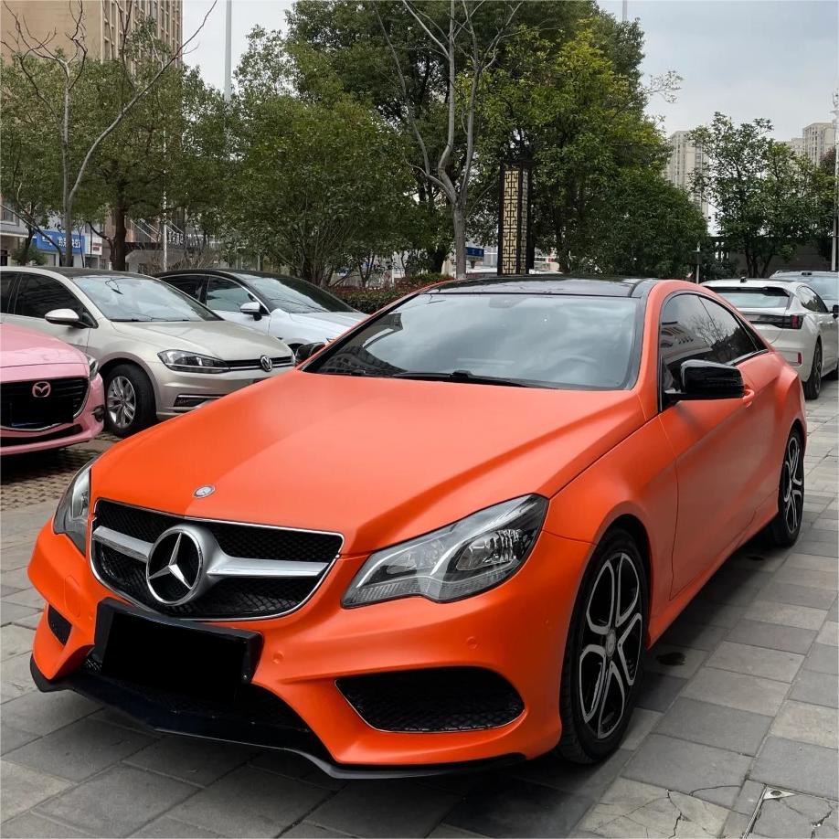 Rich molten amber sheen shimmering across premium ALUKOCARWRAP Satin Chrome Car Wrap PET vinyl on a sports car body.