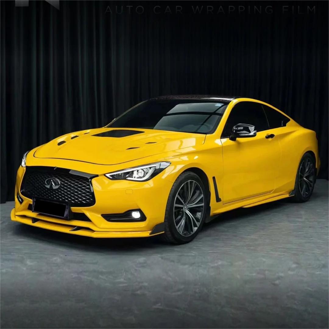 Bubble-free installation of ALUKOCARWRAP gloss sunflower yellow car wrap showing flexible metallic sparkle film on vehicle contours.