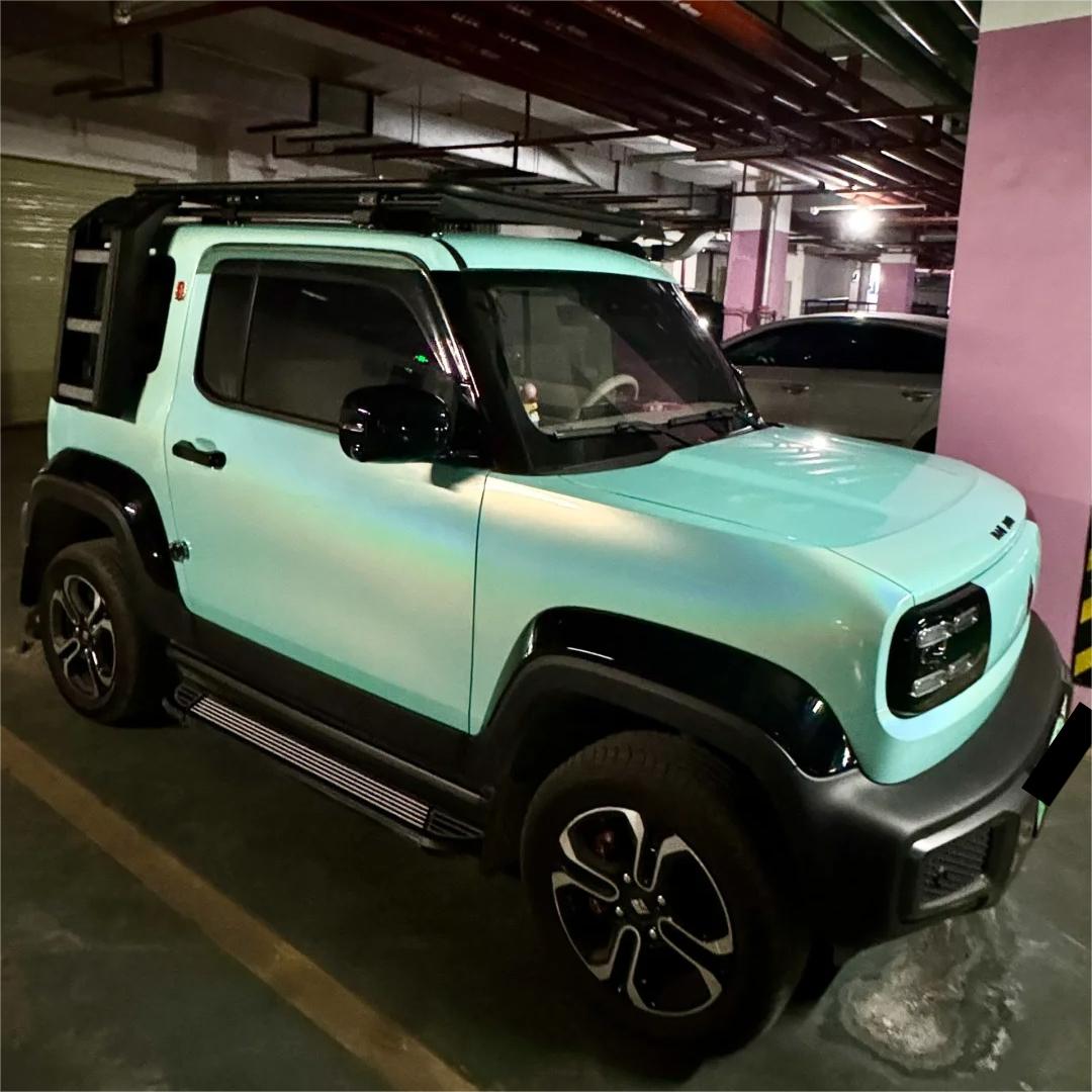 An avant-garde, high-fashion silhouette on a custom vehicle enveloped in ALUKOCARWRAP tiffany blue car wrap, exhibiting a non-glare matte metallic car wrap depth.