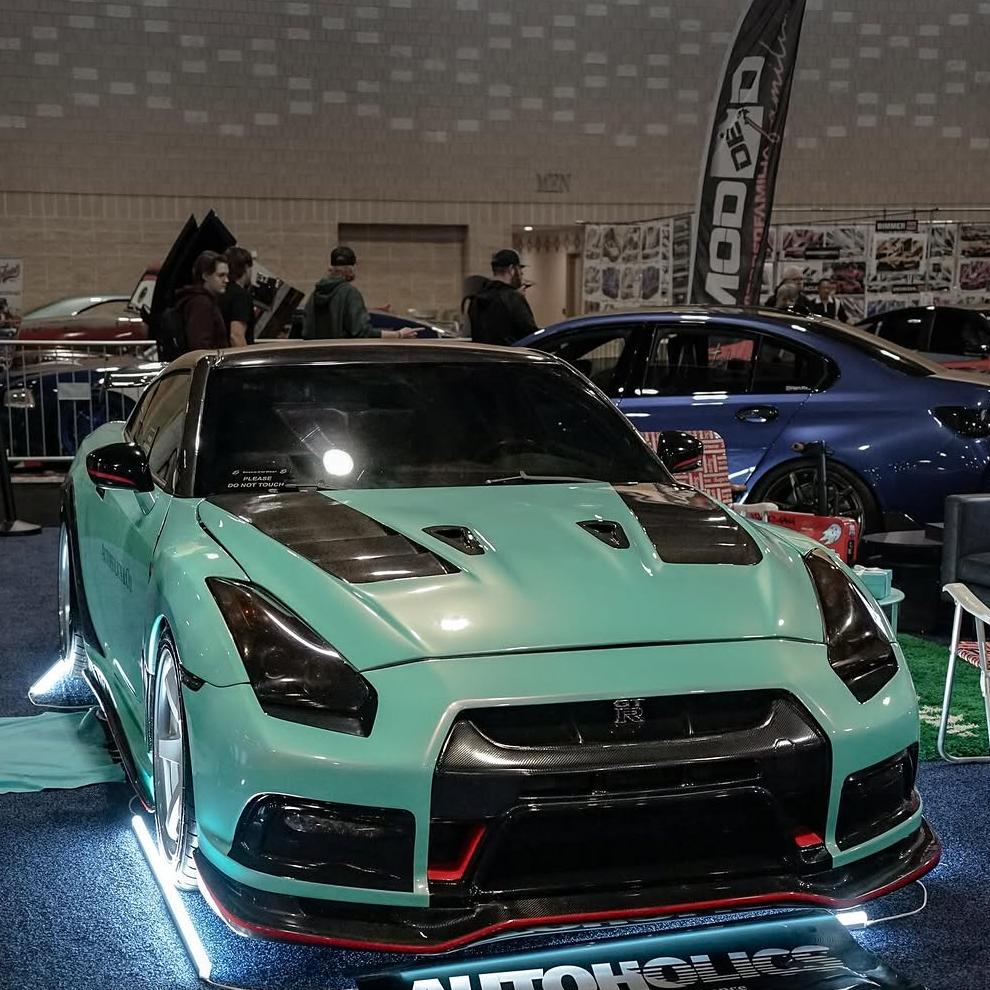 The glass-smooth hood surface of a vehicle finished in Tiffany Blue Car Wrap, exhibiting a liquid porcelain texture that perfectly diffuses overhead sunrays with crystal clarity.