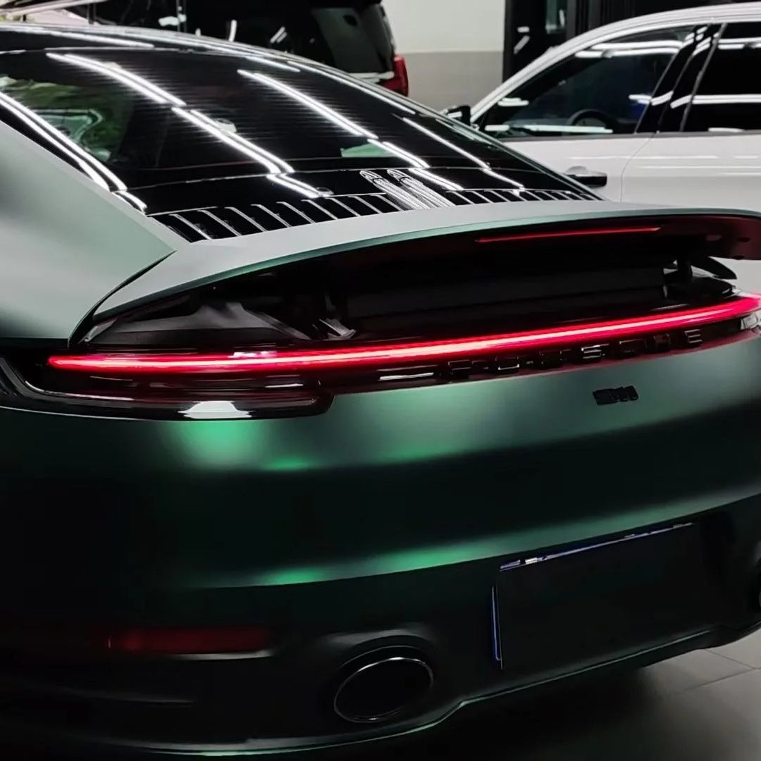 Sleek matte chrome light reflection on a car fender wrapped in Matte Metallic Chrome Venom Green Car Vinyl Wrap PET.