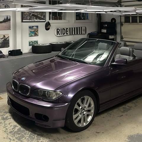 Luxury sedan stylized in ALUKOCARWRAP Violet Purple Car Wrap, demonstrating a dramatic color-shifting appearance from charcoal grey to metallic violet outdoors.