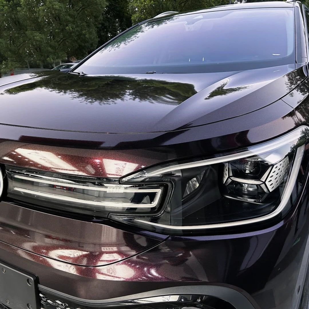 Close-up of gloss red car wrap transition by ALUKOCARWRAP, highlighting dense starry galaxy glitter flakes in the sun.