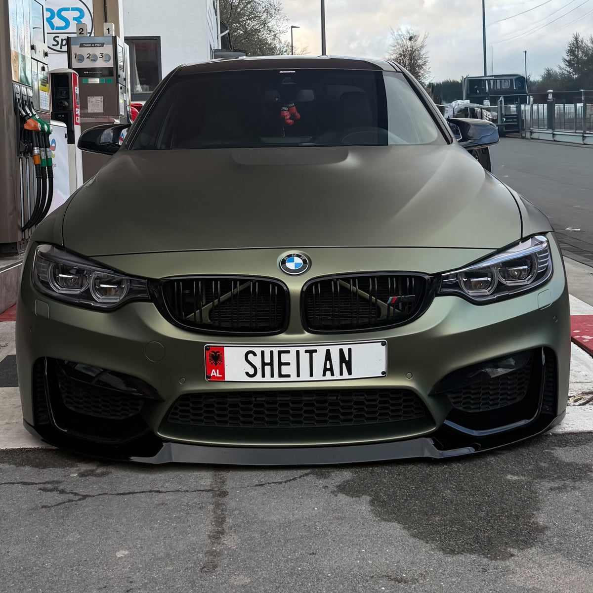 BMW M4 with metallic green vinyl wrap front view