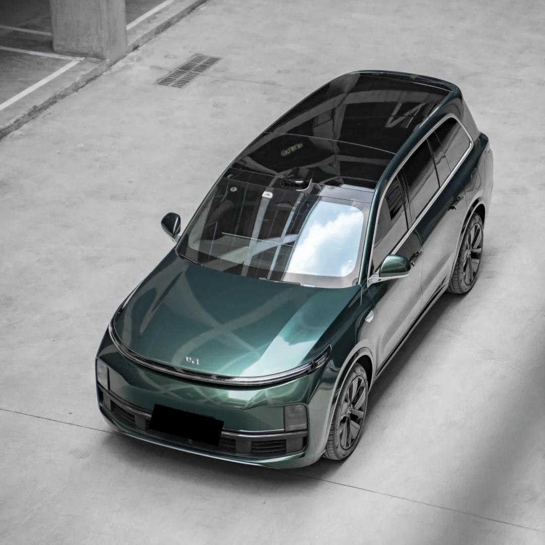 ALUKOCARWRAP gloss metallic ideal dark green car vinyl wrap on a sports car, displaying rich liquid emerald reflection.