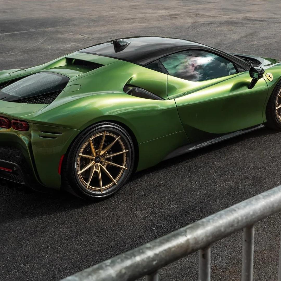 Side view of a car wrapped in gloss metallic Mamba Green highlighting its sculpted body lines