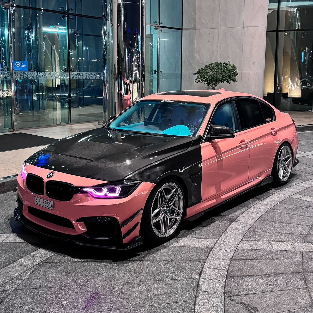 Car wrapped in gloss salmon pink vinyl with soft peach undertones and a polished finish