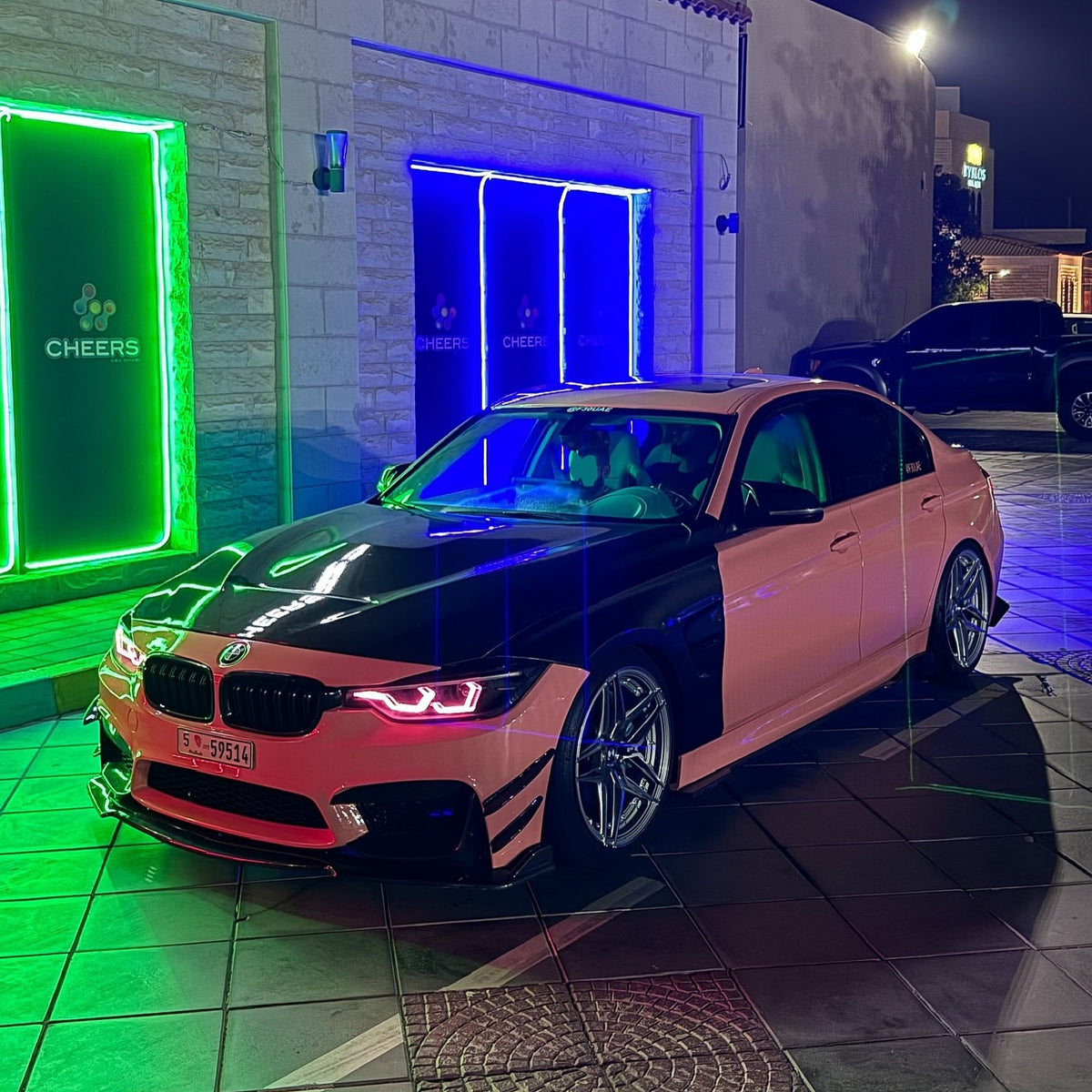 Side view of a salmon pink car wrap highlighting smooth reflections along the body panels