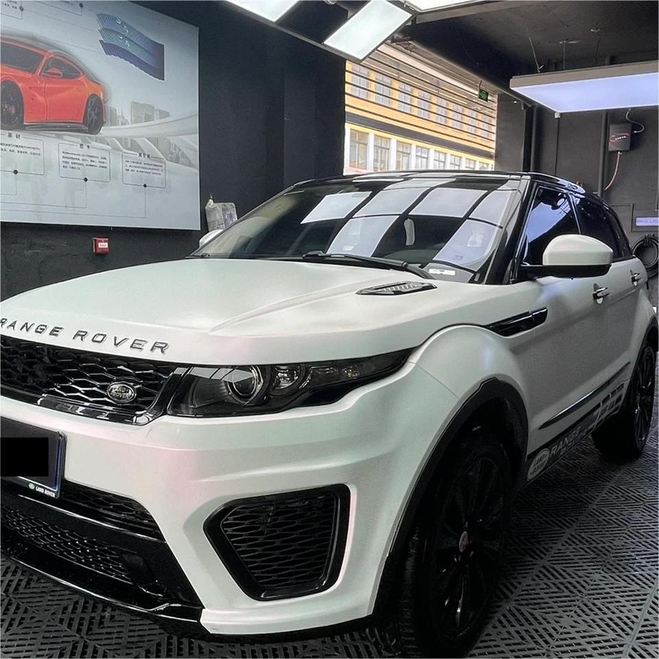 Metallic Chameleon Car Wrap on a modern SUV under showroom spotlights, revealing a premium frosted pearl paint replacement effect.