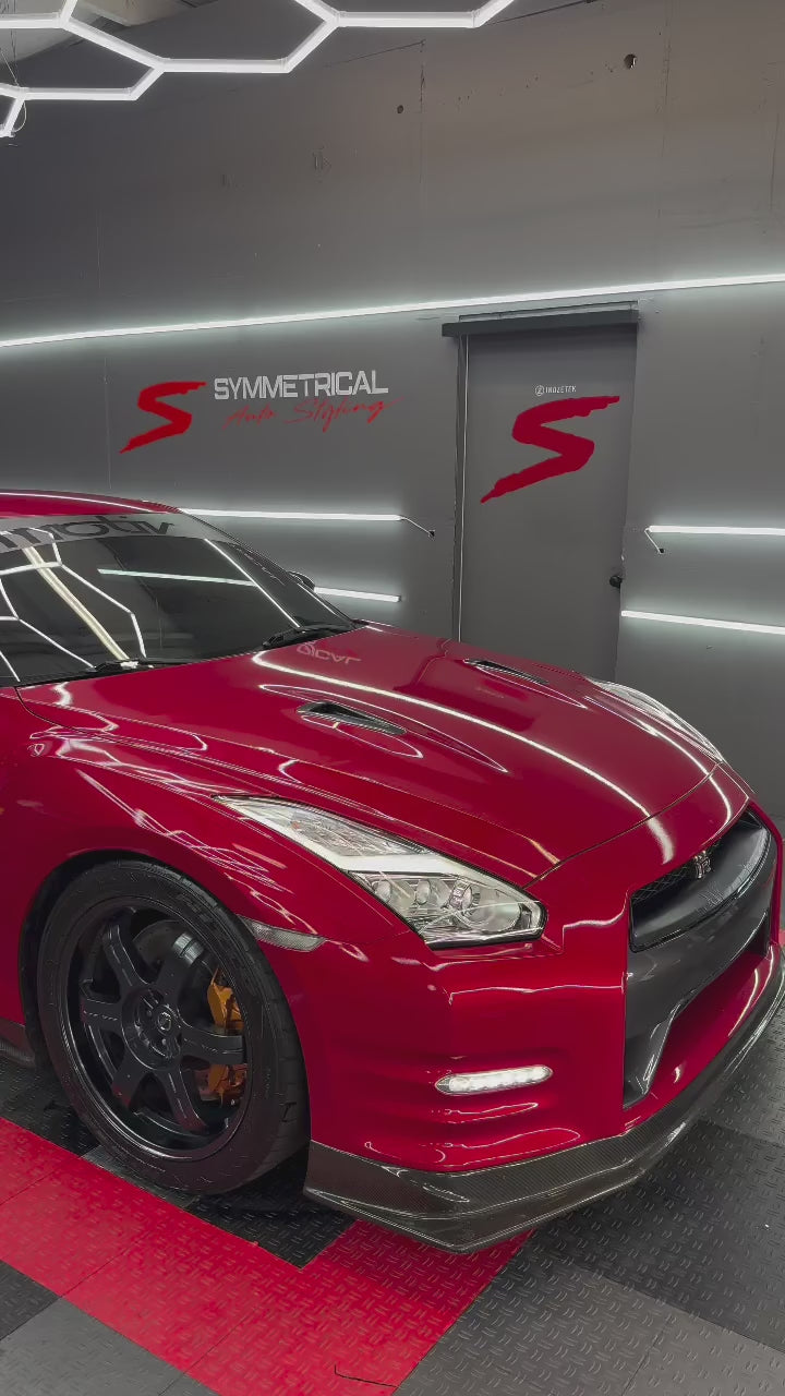 Close-up view of ALUKOCARWRAP vampire red paint protection film showing glossy metallic flakes and smooth texture.